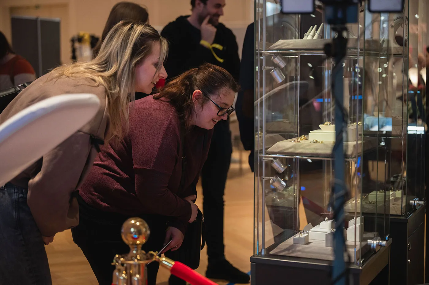 Zwei Besucherinnen betrachten Ringe in einer Schmuckvitrine